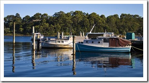 Fishing boats in the morning light in Strahan