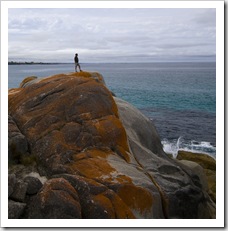 Greg standing on the rocks at Bay of Fires