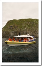 One of the Bruny Island Cruises boats amongst rocks known as The Friars