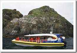 One of the Bruny Island Cruises boats amongst rocks known as The Friars
