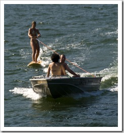 Lisa riding the surfboard in Lake Conjola