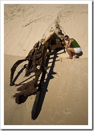 A vehicle flipped in the sand at Sandy Cape