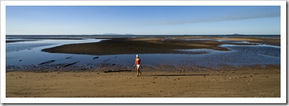 Lisa on the beach in front of our campsite at Toomulla