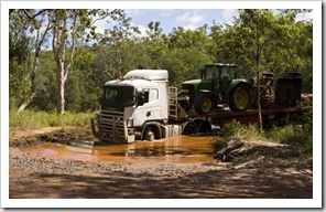 Truck with two trailers tackling the water crossings on Battle Camp Road