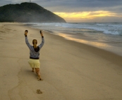 Lisa doing her morning exercises on the beach at sunrise in Hat Head National Park